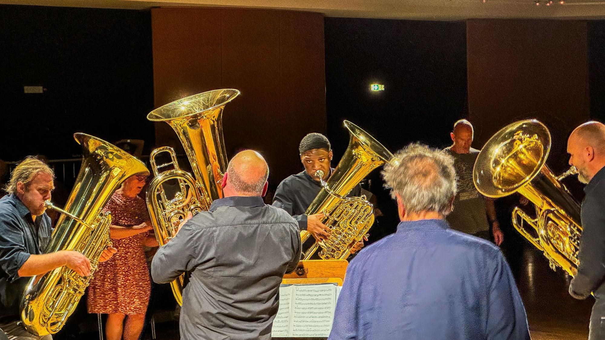 Vier Tuba-Spieler stehen im Kreis und musizieren.