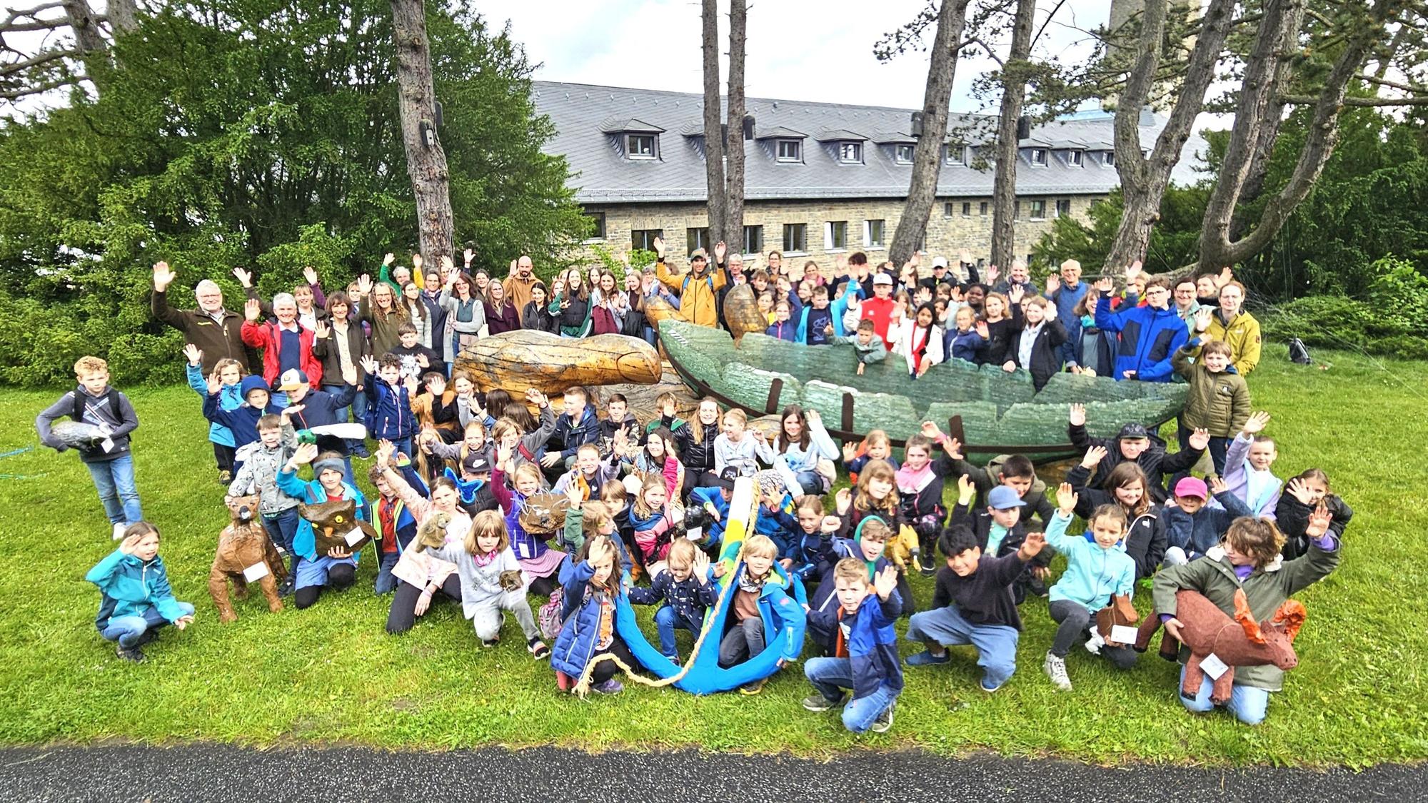 Schüler, Lehrer und Mitarbeiter der Nationalparkverwaltung stehen und sitzen um die Glasarche herum.