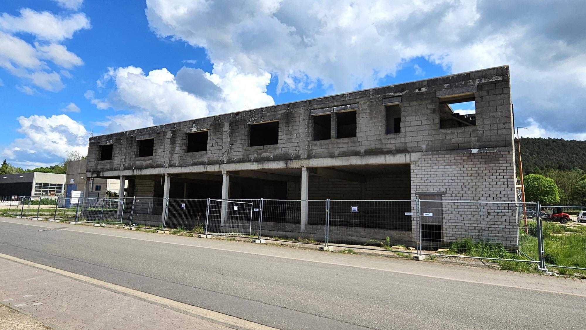Blick auf den direkt an der Straße stehenden Rohbau.