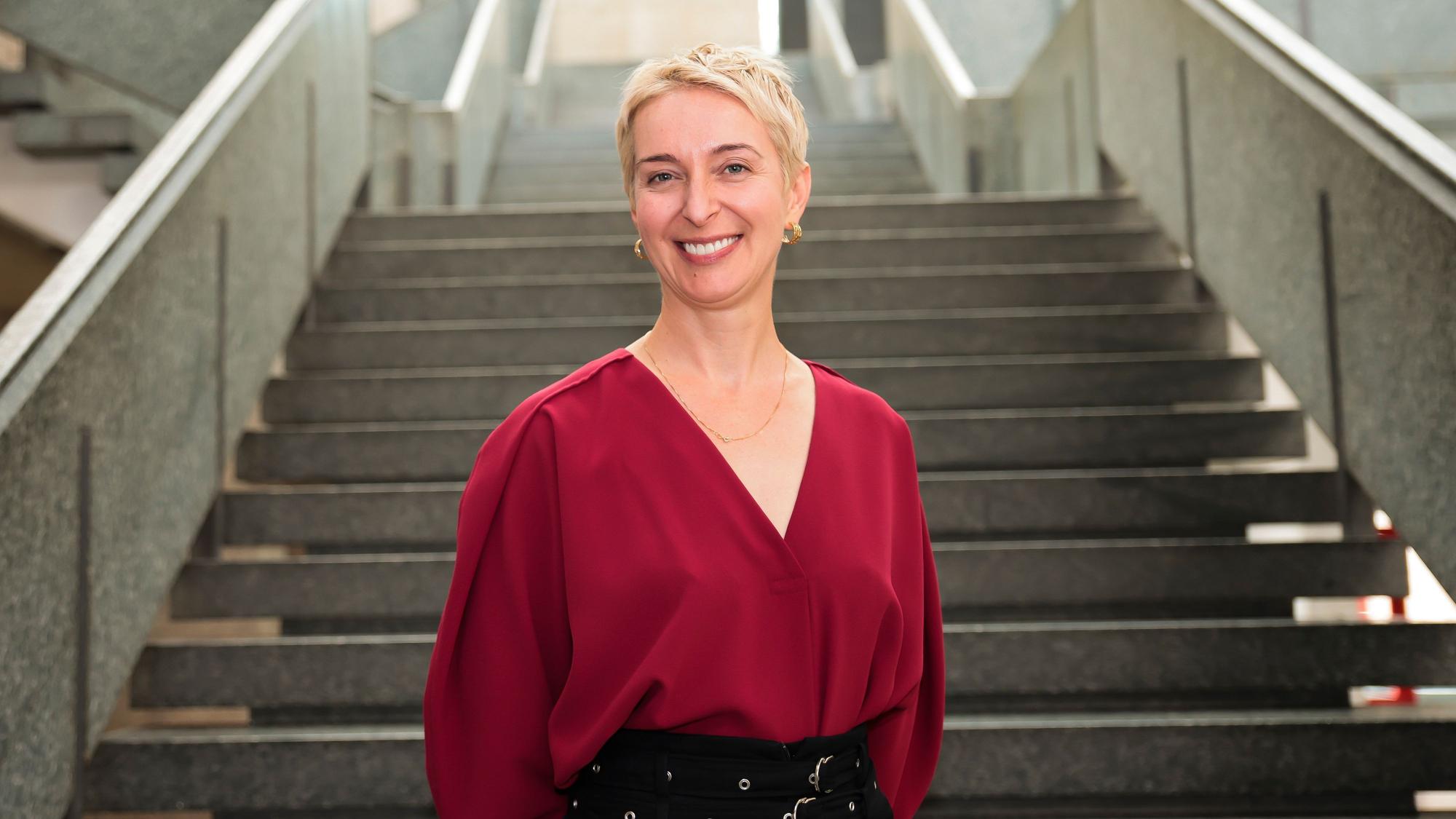 Ewa Bogusz-Moore steht vor einer Treppe.