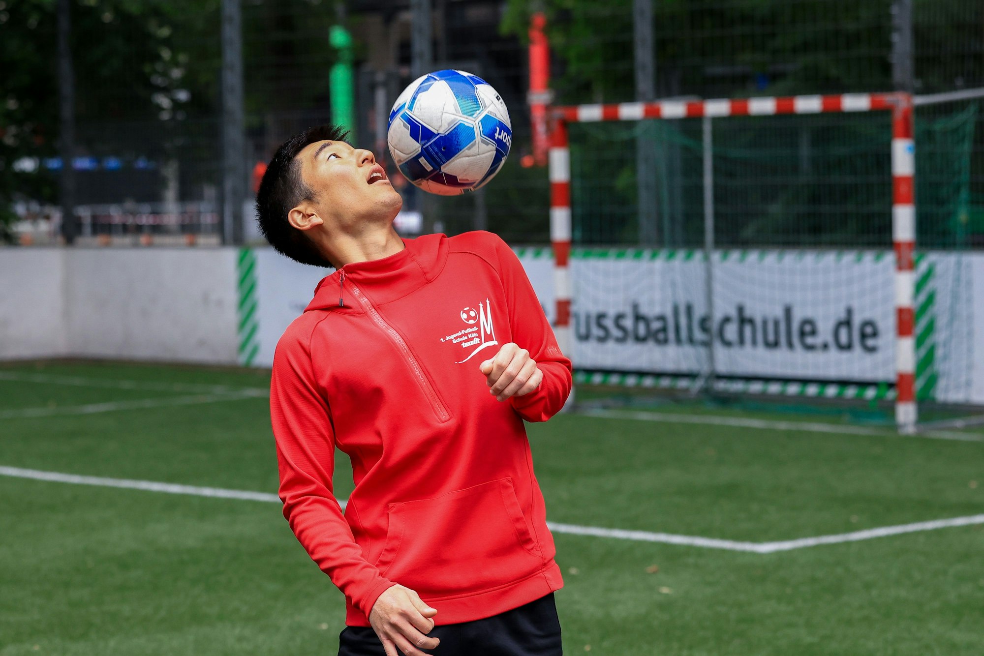 Trainer Kei Tomonaga zeigt den „Schulterkick“: Er lässt den Ball auf einer Schulter hüpfen.