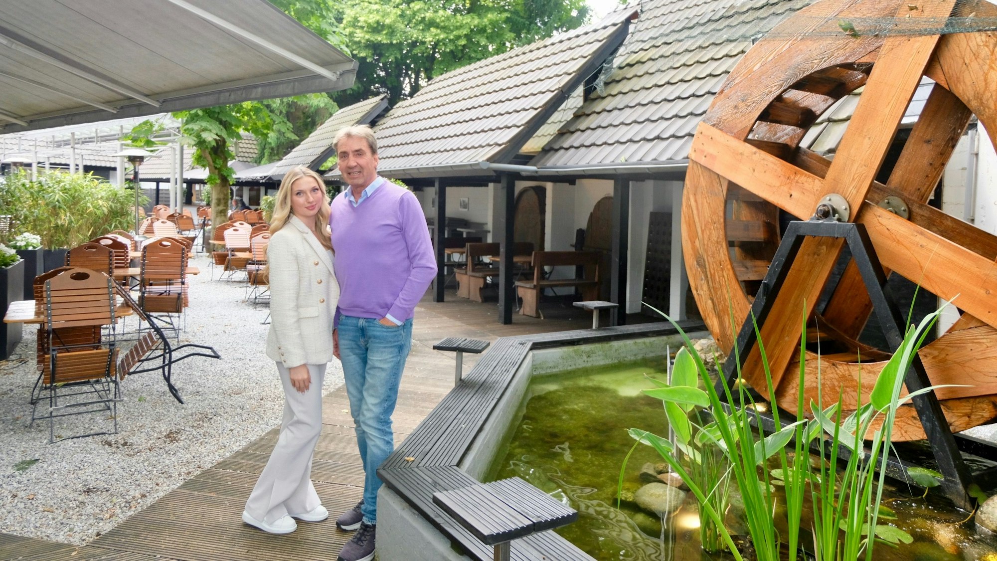 Celina und Robert Schumacher im Biergarten der Decksteiner Mühle neben dem Mühlenrad.