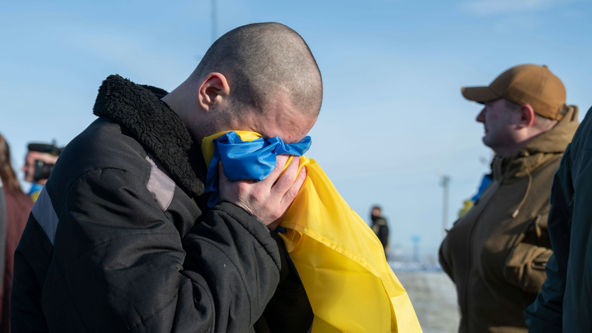 Ein ukrainischer Soldat weint in die Flagge seines Landes nach seiner Rückkehr aus russischer Kriegsgefangenschaft. (Archivbild)