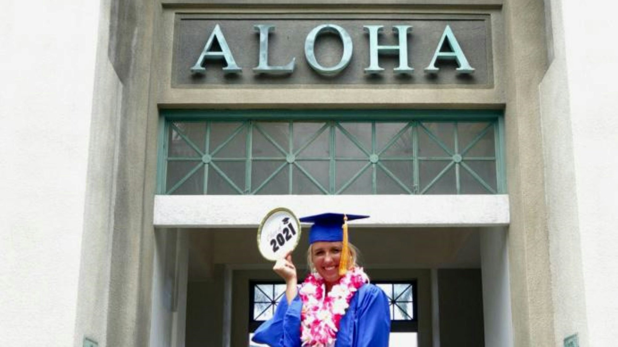 Bild einer jungen Frau, die vor einer Universität steht