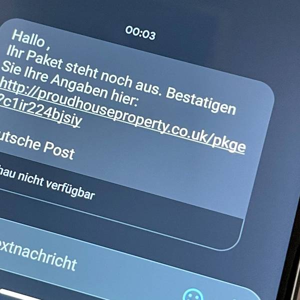 Ein Handyscreen mit dem Text „Ihr Paket steht noch aus. Betätigen Sie Ihre Angaben hier “(Link folgt).