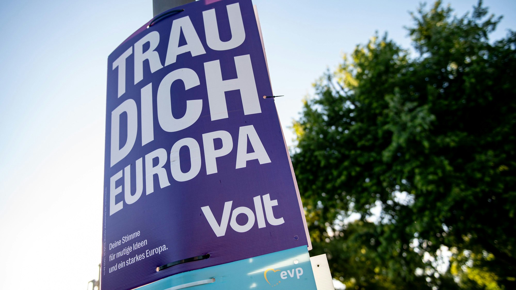 Ein Wahlplakat der Partei «Volt» hängt an einer Straßenlaterne.
