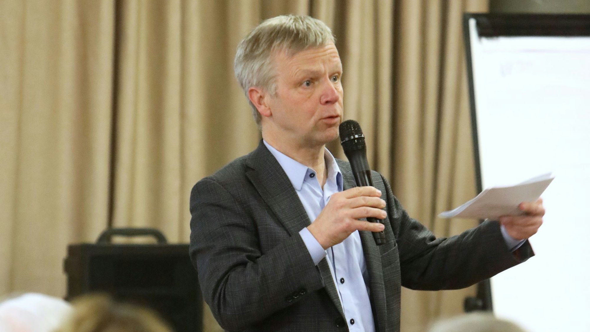 Ein Mann mit einem Mikro in der Hand.