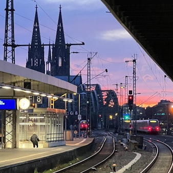 Der Bahnhof in Köln-Deutz im Abendlicht, im Hintergrund die Türme des Kölner Doms.