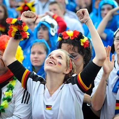 Besucher und Besucherinnen jubeln 2014 beim Public Viewing des WM-Fußballspiels Deutschland gegen USA.