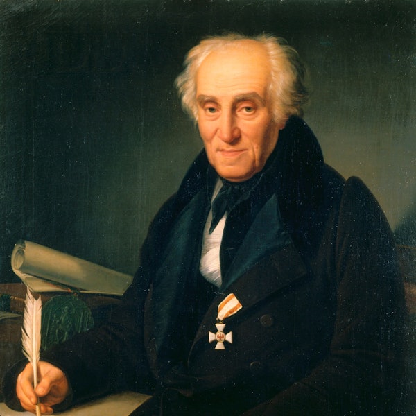 Ein älterer Mann schaut den Betrachter gütig an.