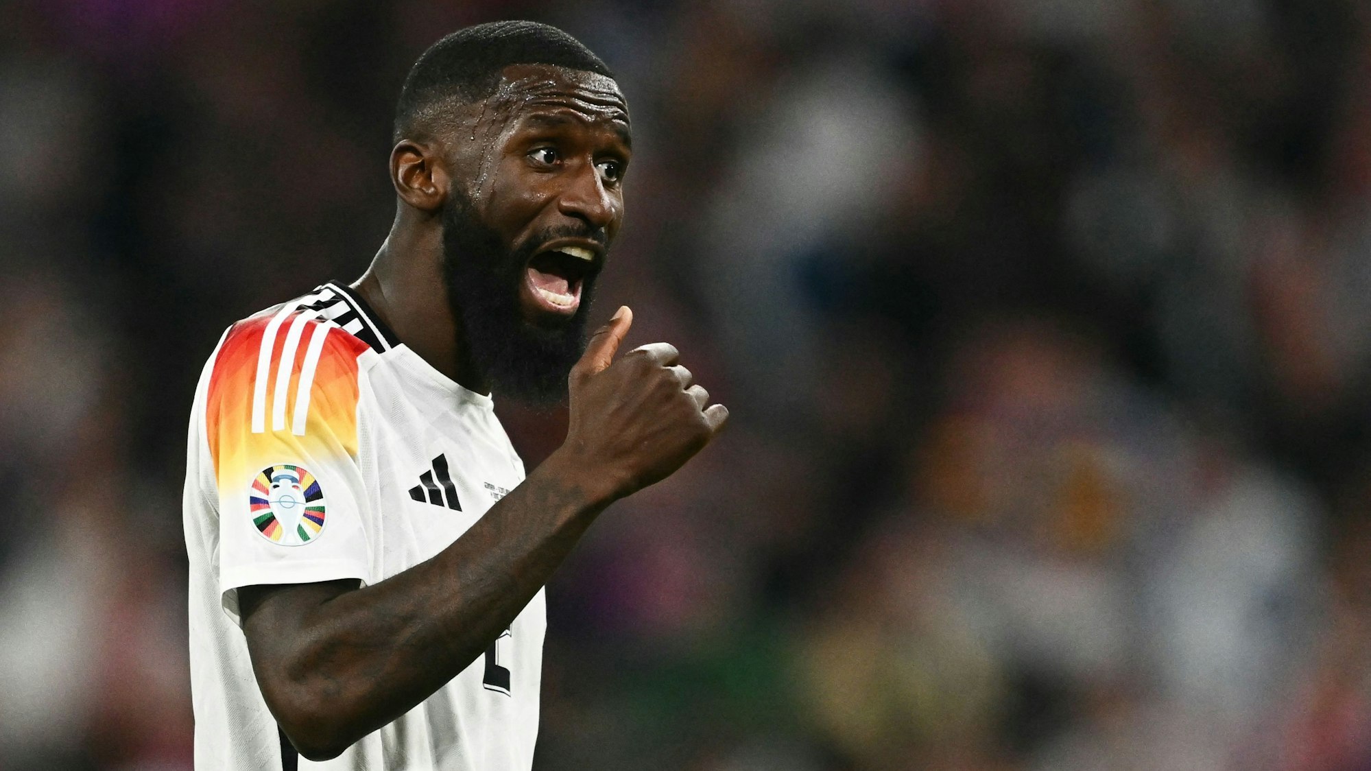 Germany's defender #02 Antonio Ruediger reacts during the UEFA Euro 2024 Group A football match between Germany and Scotland at the Munich Football Arena in Munich on June 14, 2024. (Photo by Fabrice COFFRINI / AFP)