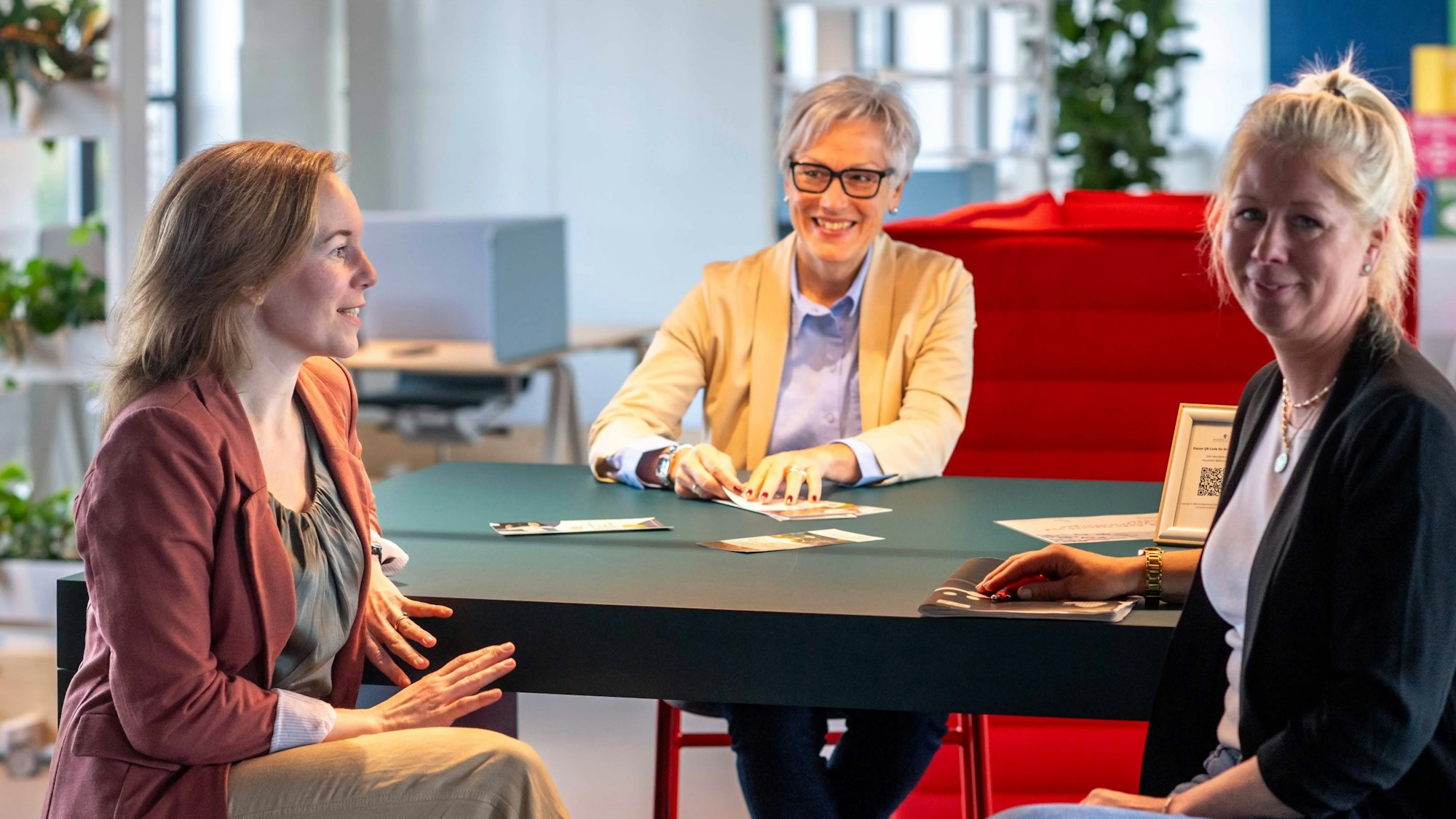 Isabelle Jaeschke, Iris Poth und Sarah Komp sitzen an einem Tisch.