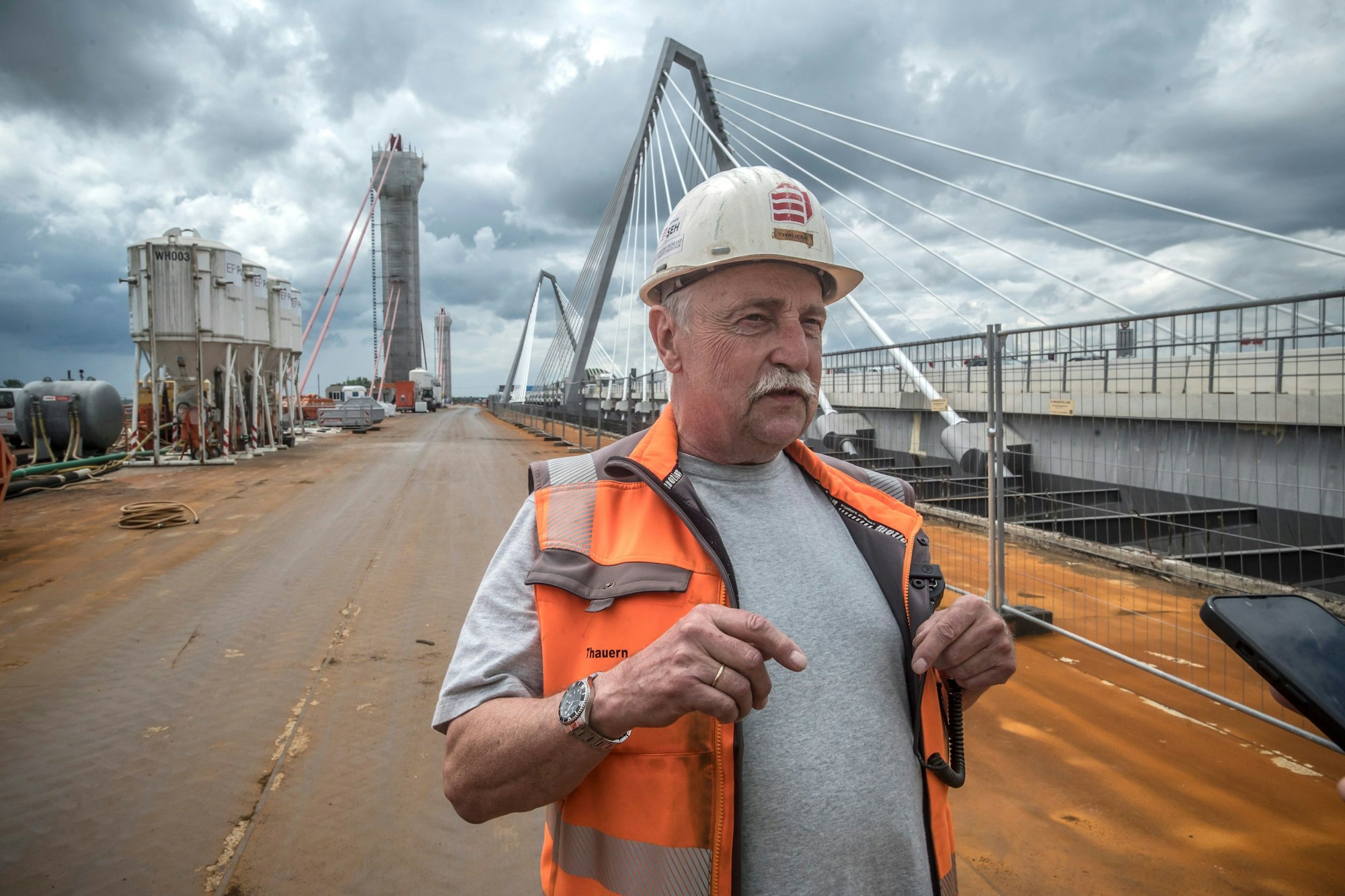 Projektleiter Bernd Thauern steht auf der alten Brücke und erklärt den technischen Vorgang des Trennschnitts.