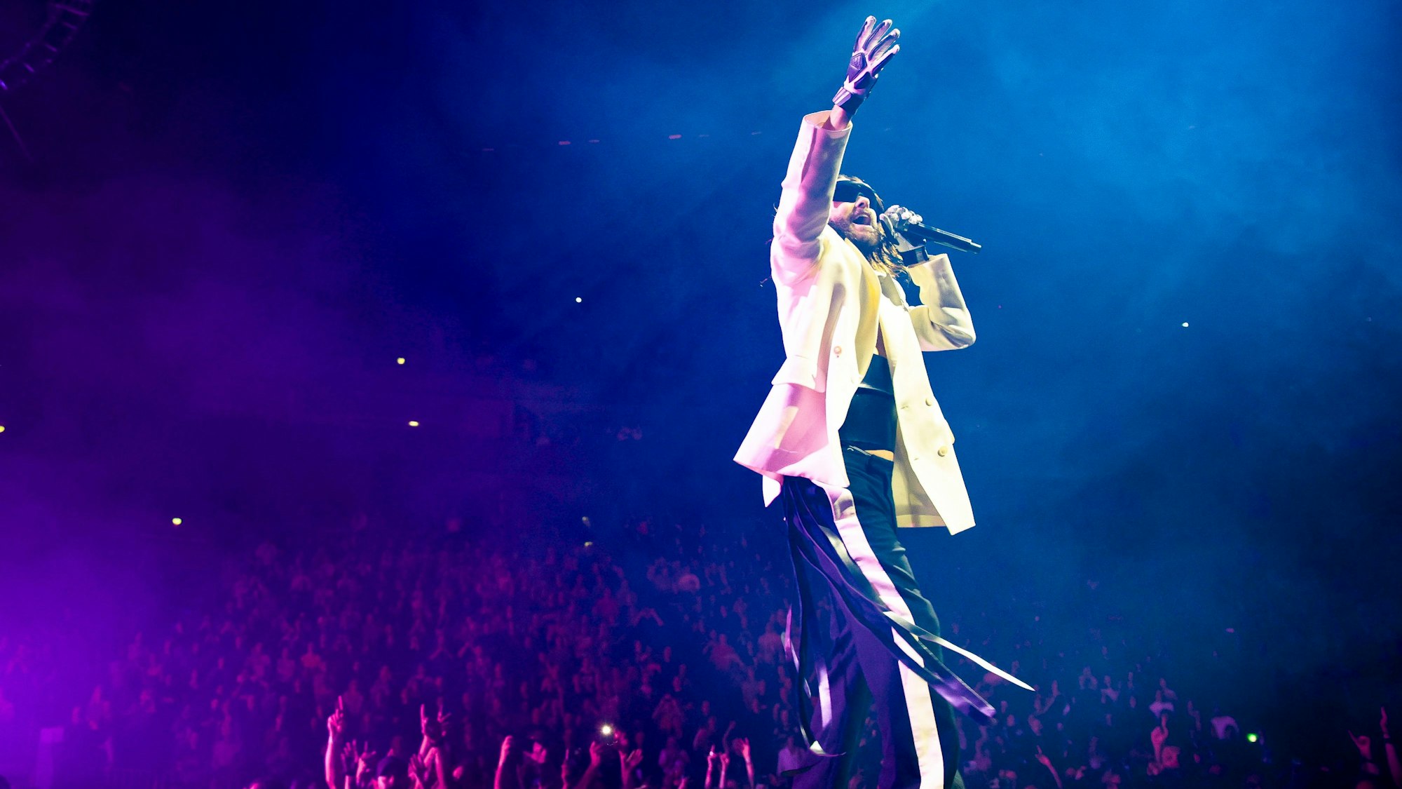 Jared Leto singt auf der Bühne, im Hintergrund geht das Publikum leidenschaftlich und jubelnd mit.