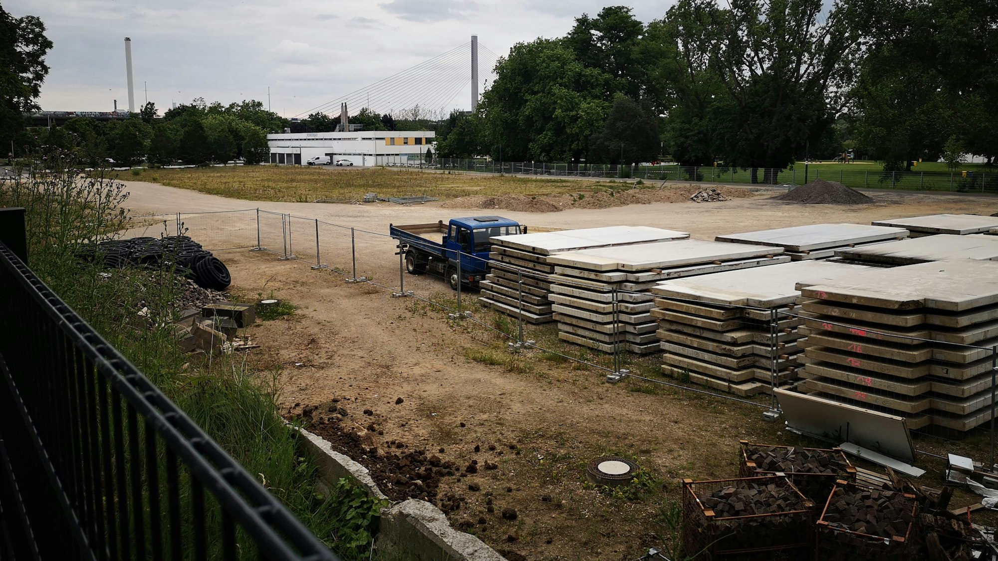 Eine Brachfläche mit Bauplatten ist zu sehen.