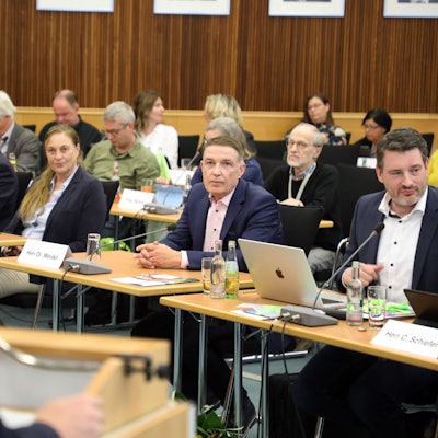 Ex-Kreisdirektor Dr. Erik Werdel sitzt zwischen Politikern im Kreistag, Landrat Stephan Santelmann spricht am Rednerpult.