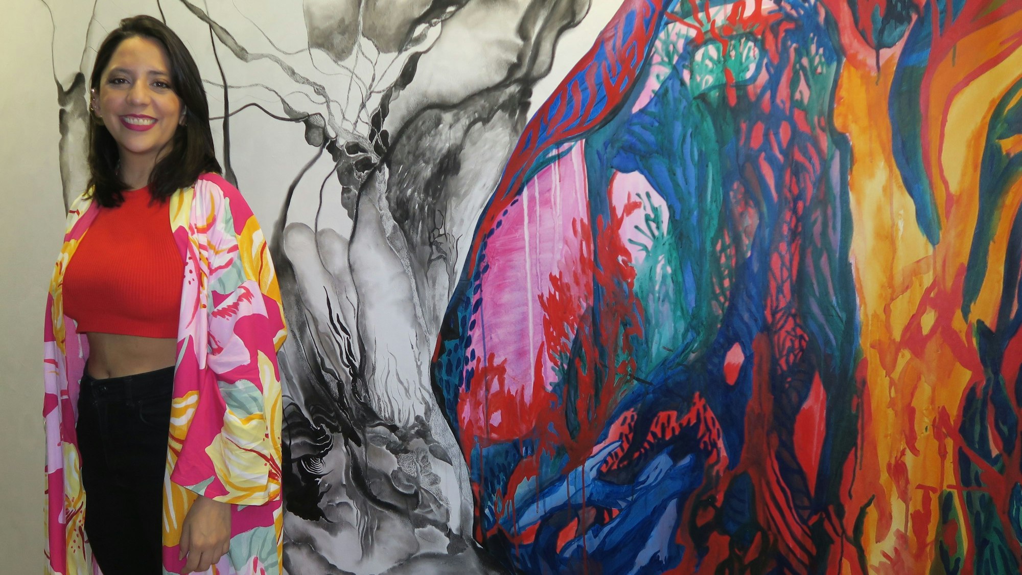 Die argentinische Künstlerin Basilia Guadalupe Perez Obregón neben einem ihrer Bild in der Neuehrenfelder „Eine-Art-Passage.