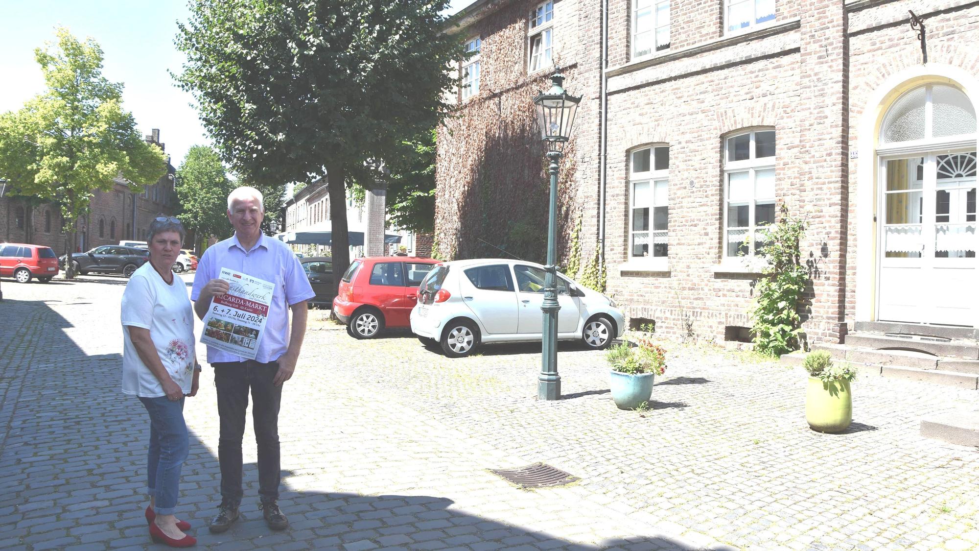 Eine Frau und ein Mann stehen auf der Straße in einer Alt-Stadt.
