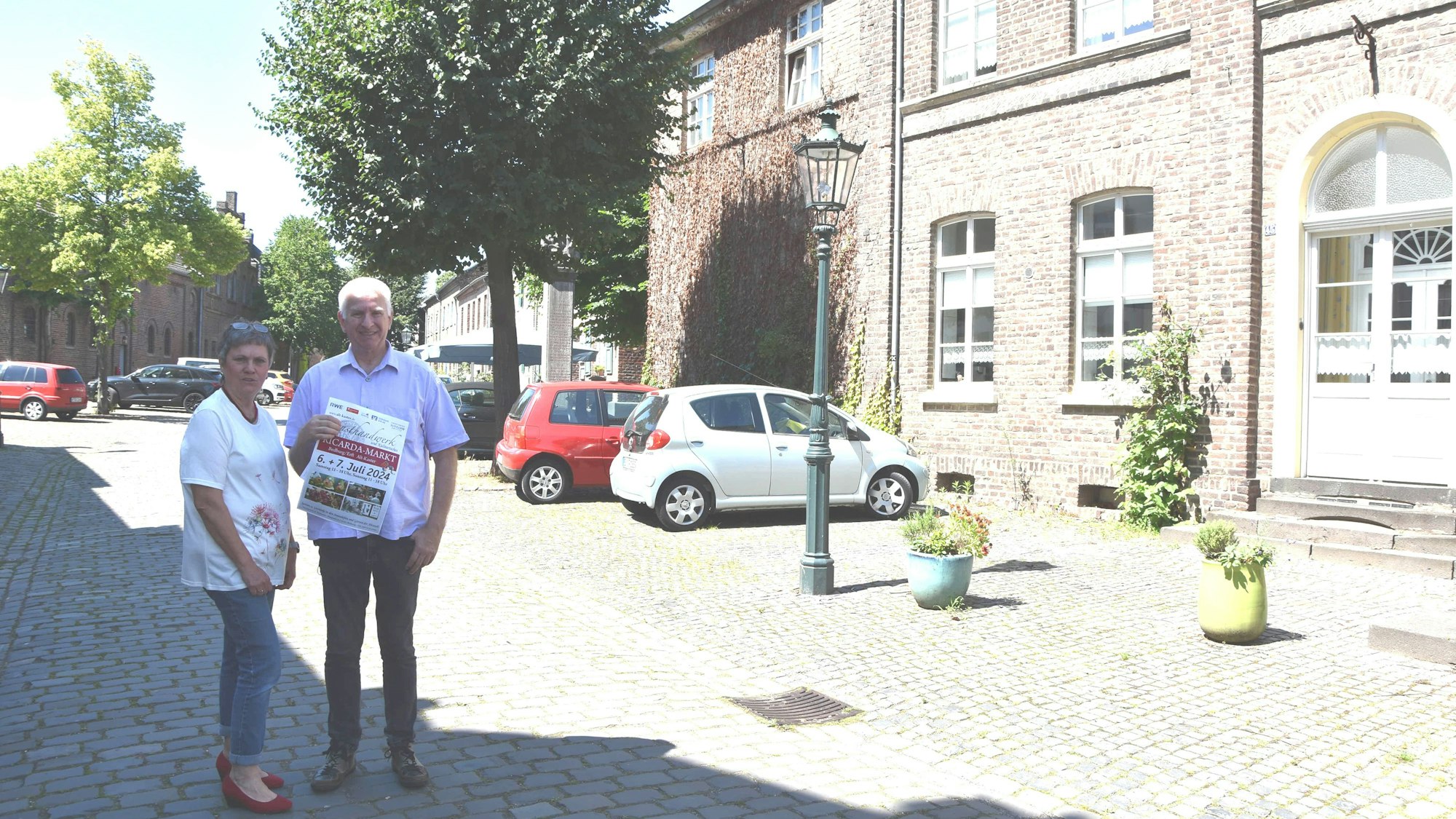 Eine Frau und ein Mann stehen auf der Straße in einer Alt-Stadt.