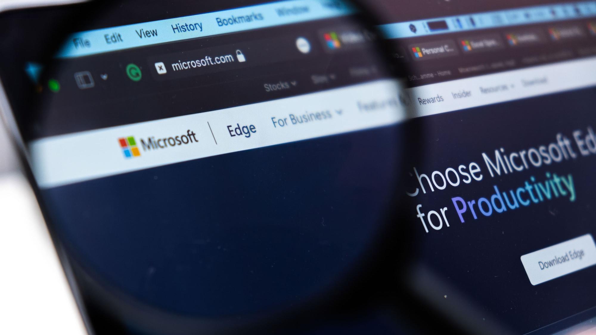 Durch eine Lupe sieht man einen Teil der Microsoft-Website im Browser Microsoft Edge.