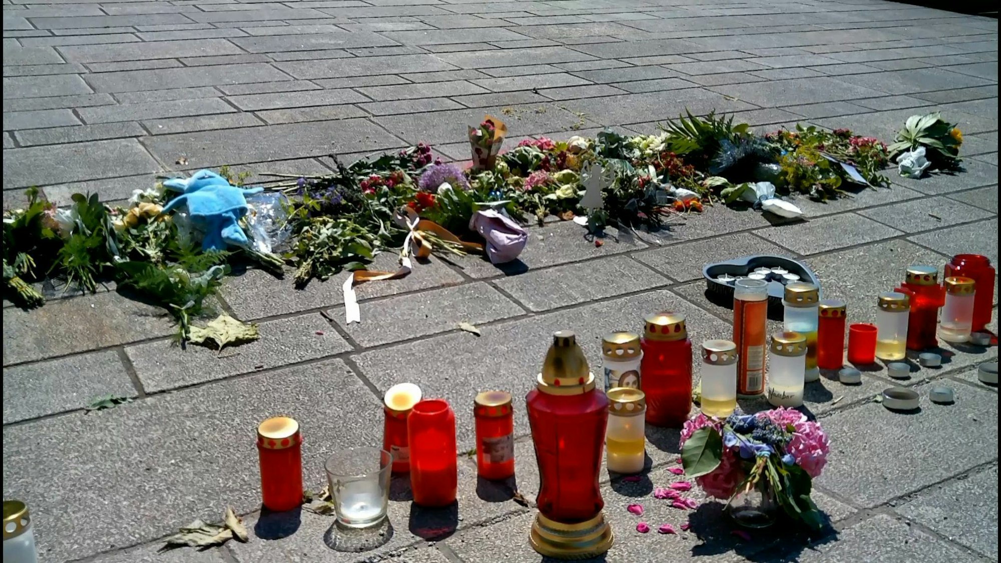Trauernde haben Blumen und Kerzen an der Stelle der tödlichen Attacke im Kurpark in Bad Oeynhausen niedergelegt.