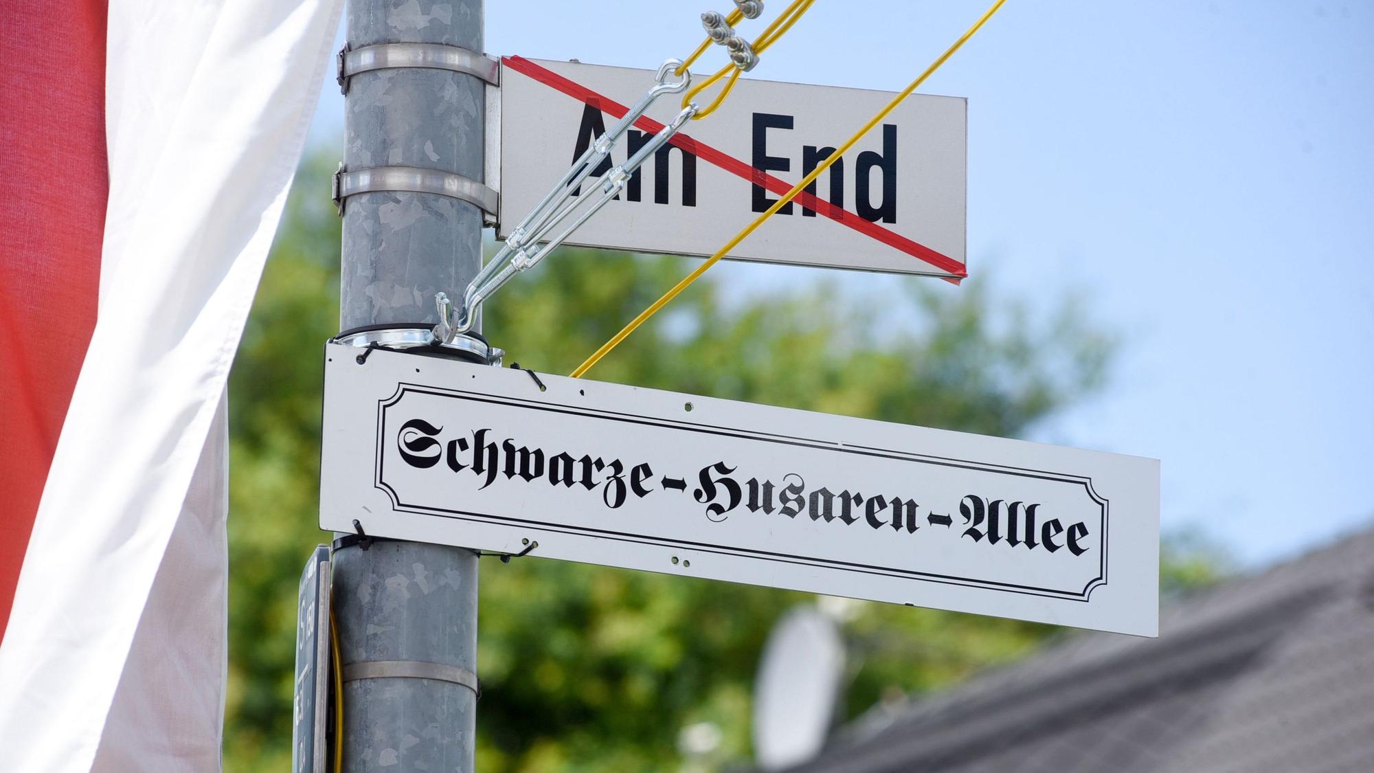 Auf dem Bild ist ein geändertes Straßenschild zu sehen.