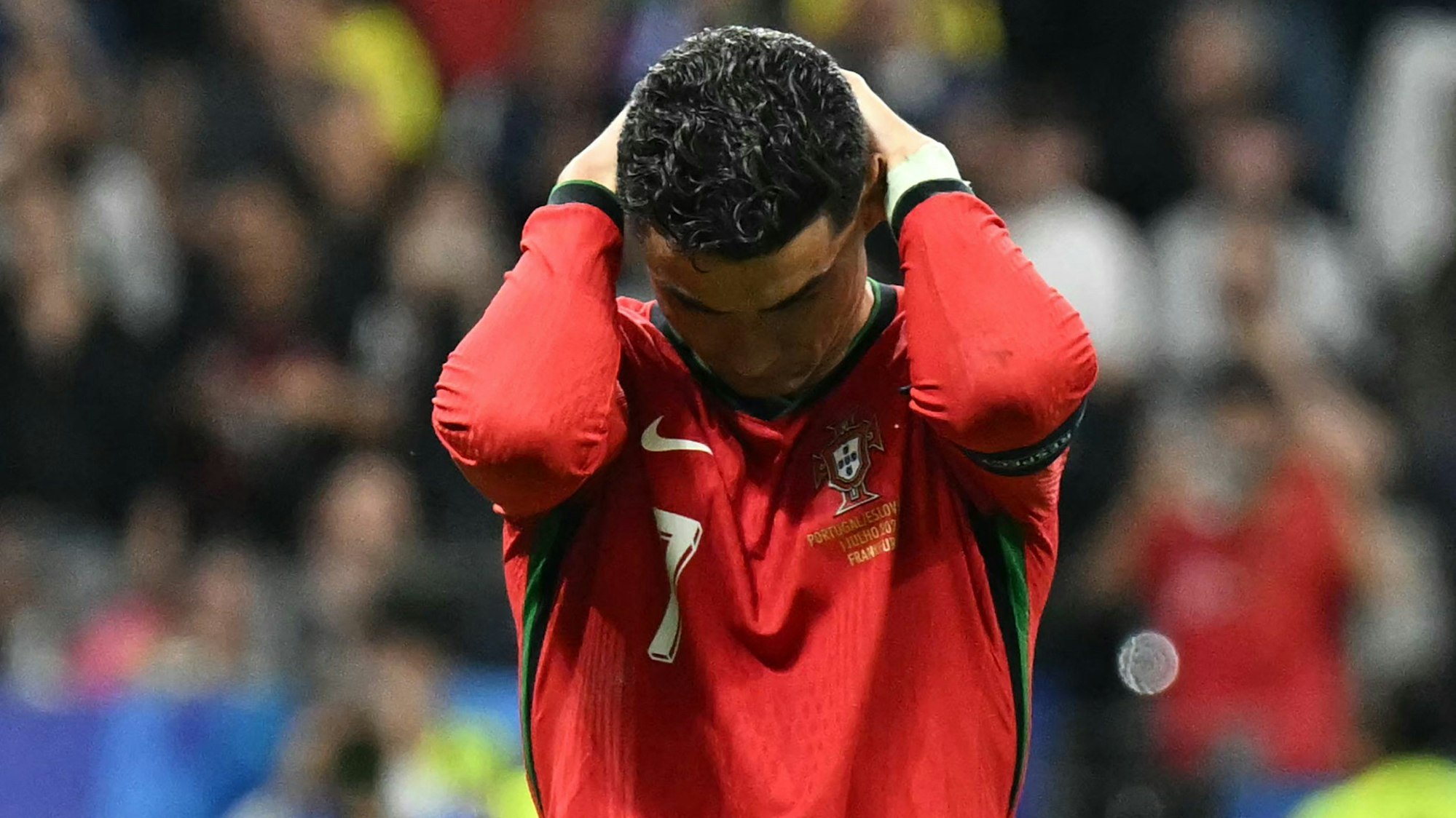 TOPSHOT - Portugal's forward #07 Cristiano Ronaldo reacts after failing to score a penalty kick during the UEFA Euro 2024 round of 16 football match between Portugal and Slovenia at the Frankfurt Arena in Frankfurt am Main on July 1, 2024. (Photo by PATRICIA DE MELO MOREIRA / AFP)