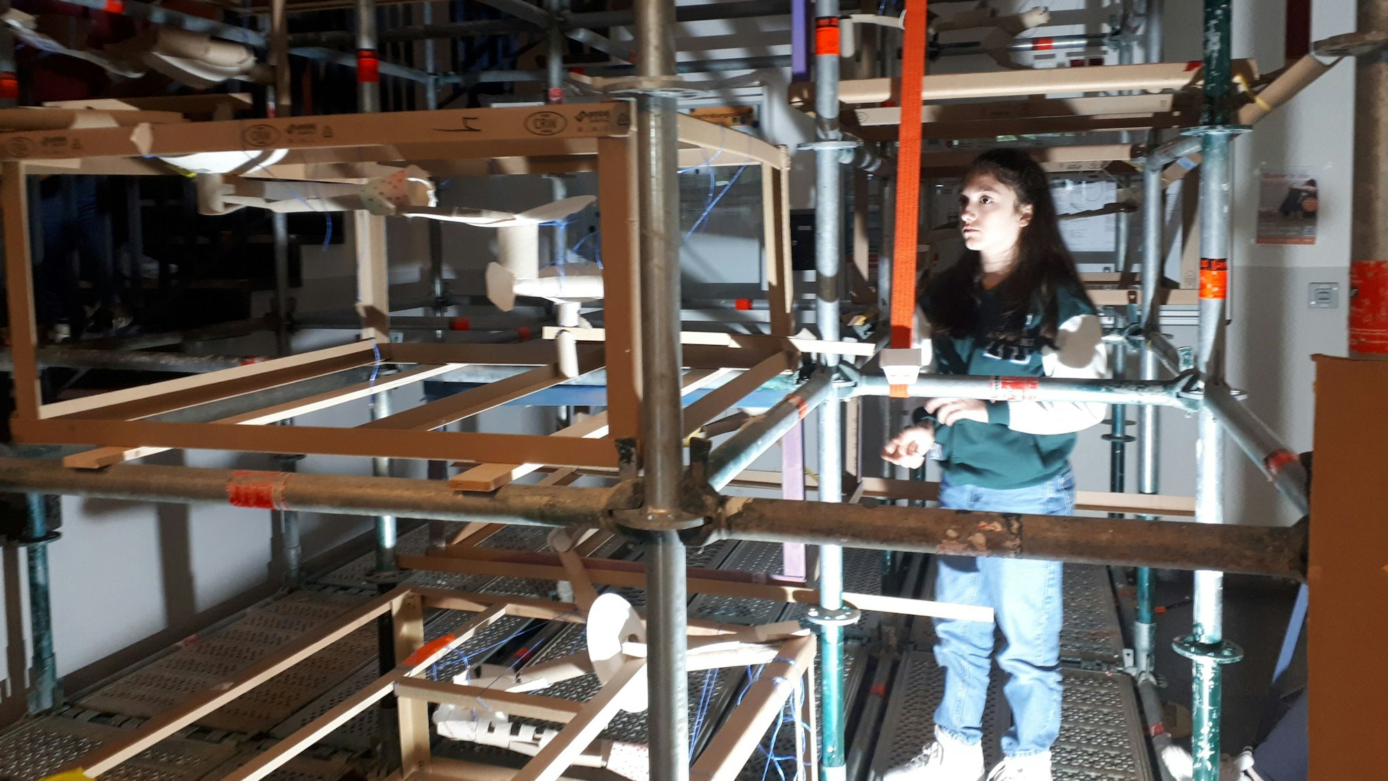 In einem Gerüst ist eine Murmelbahn aufgebaut.