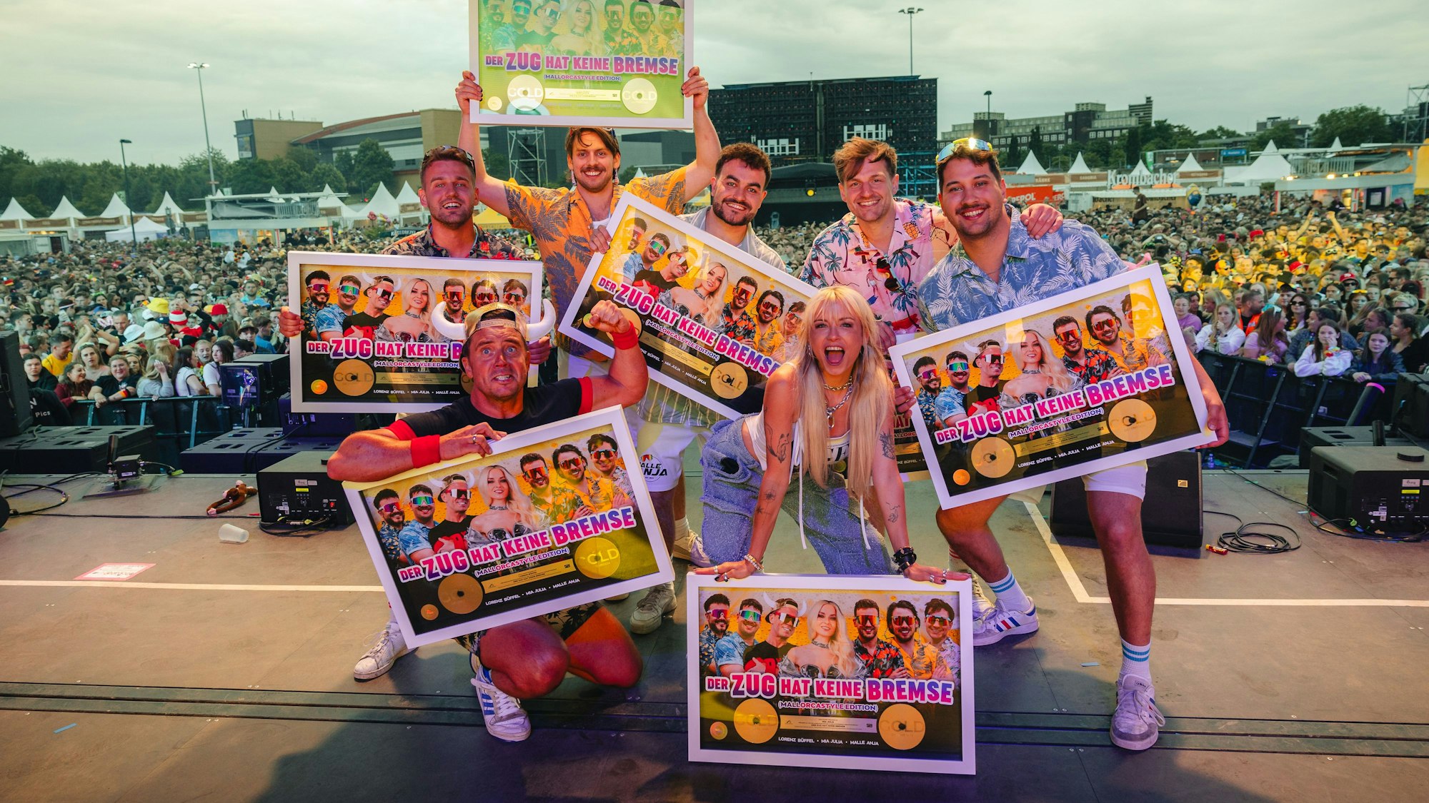 Die Kölner Band Malle Anja (hinten), Mia Julia und Lorenz Büffel (vorne) freuen sich über eine Goldene Schallplatte.