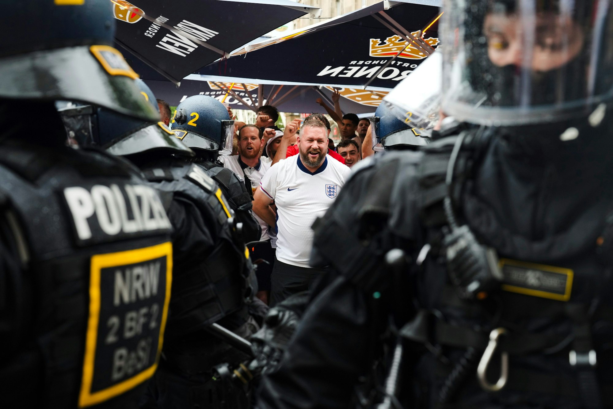 England fans speak with police officers as they celebrate ahead of a semi final match between Netherlands and England at the Euro 2024 soccer tournament in Dortmund, Germany, Wednesday, July 10, 2024. (AP Photo/Markus Schreiber)