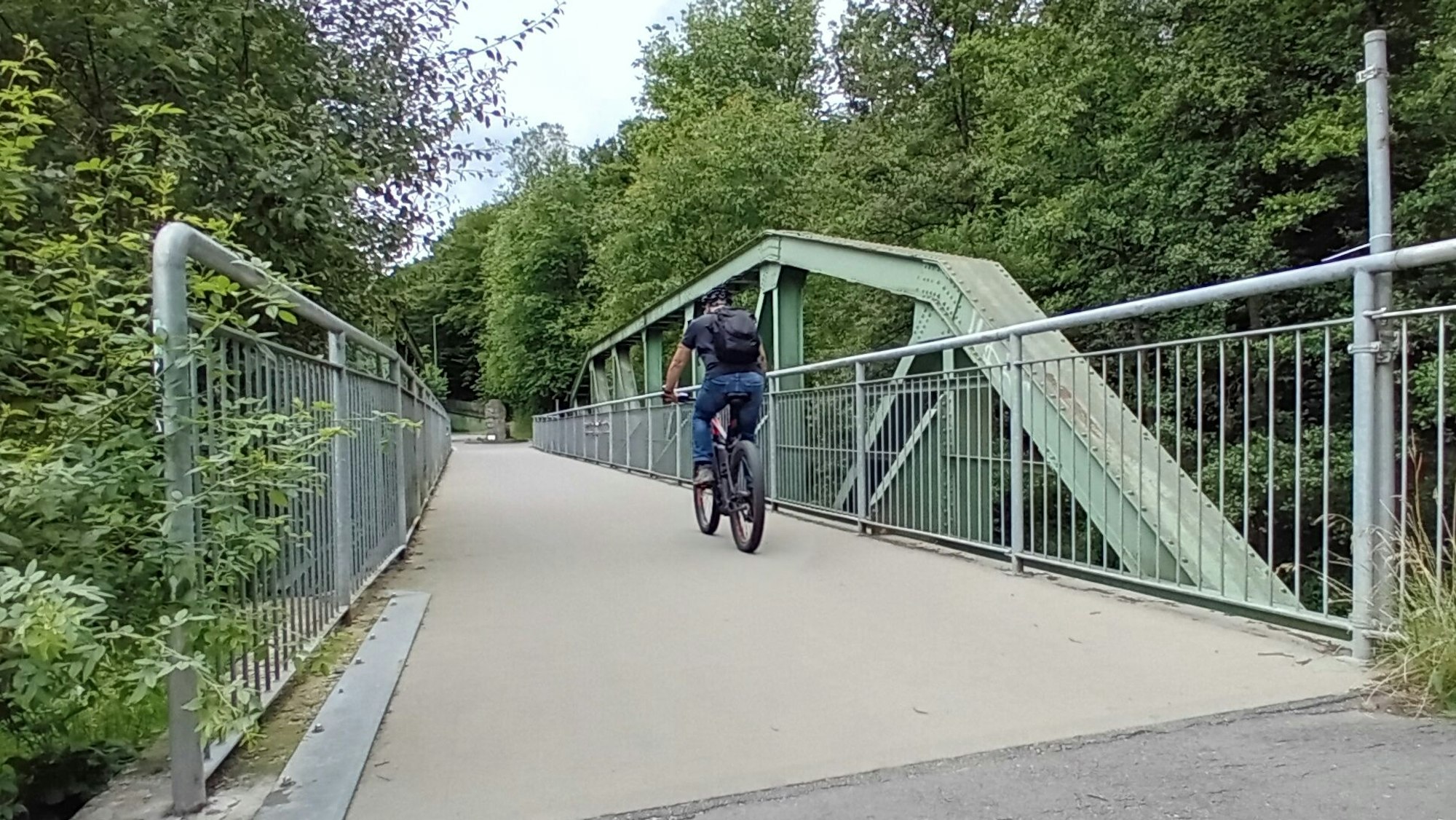 Ein Radfahrer auf einer Brücke.