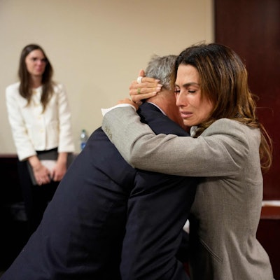 US actor Alec Baldwin and his wife Hilaria Baldwin embrace during his trial on involuntary manslaughter at Santa Fe County District Court in Santa Fe, New Mexico, on July 12, 2024. Baldwin's trial for involuntary manslaughter was dismissed by a judge Friday after she ruled that key evidence over a fatal shooting on the set of "Rust" had been withheld from the defense. (Photo by Ramsay de Give / POOL / AFP)