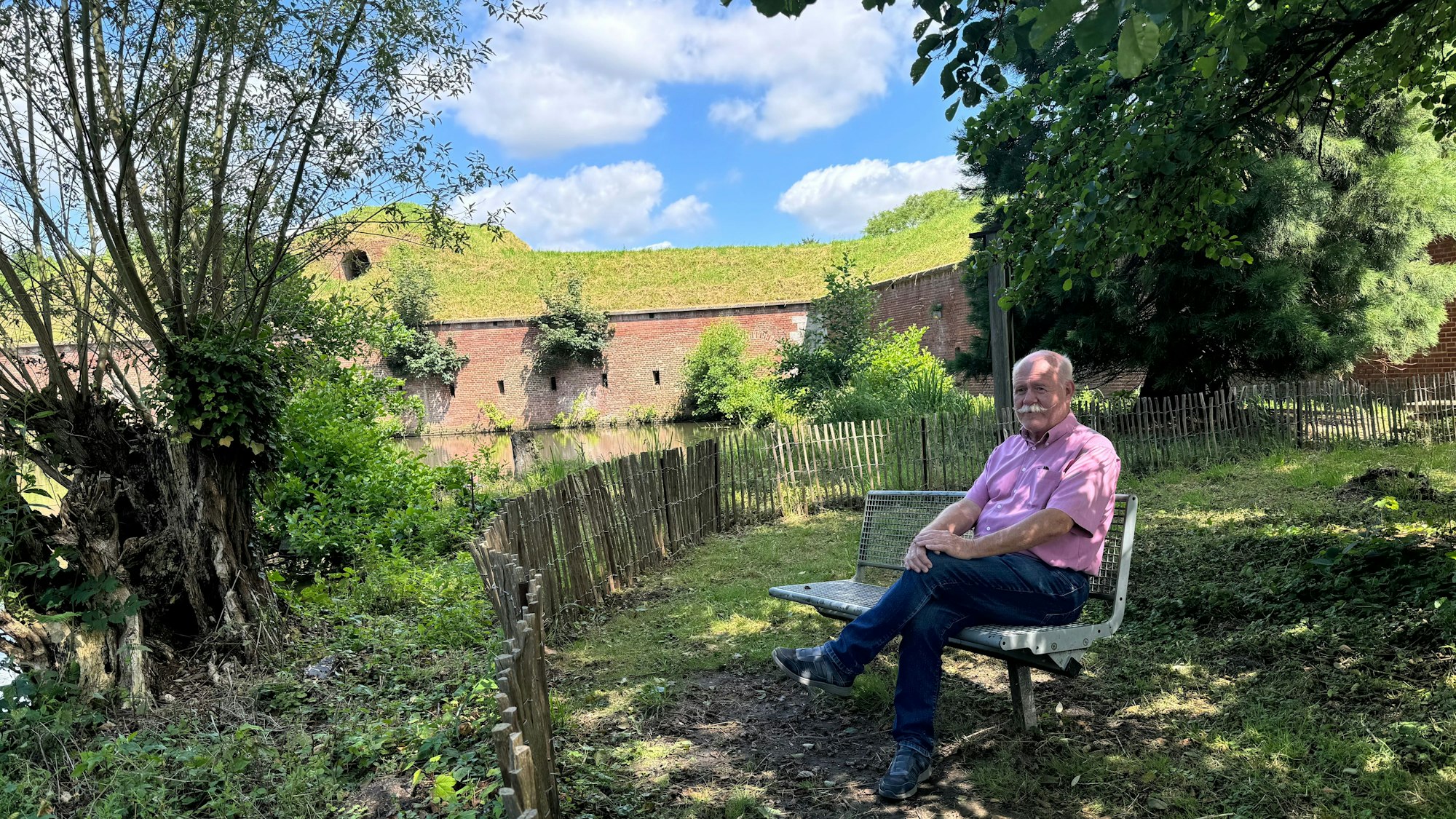 Hans-Josef Bülles sitzt an seinem Lieblingsplatz im Brückenkopfpark: Dem Ort der Stille hinter der Festung.