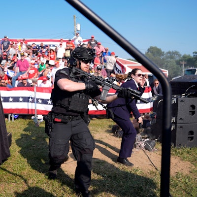 Einsatzkräfte stürmen die Bühne während einer Wahlkampfveranstaltung mit Donald Trump. Trump wurde bei einem Schusswaffenangriff auf der Bühne am Ohr verletzt. Der mutmaßliche Schütze wurde von Sicherheitskräften getötet.