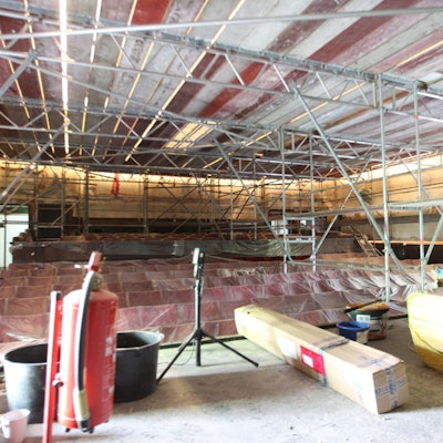 Blick in den Kino-Saal mit abgedeckten Stuhlreihen und komplett eingerüsteten Wänden und Decke.