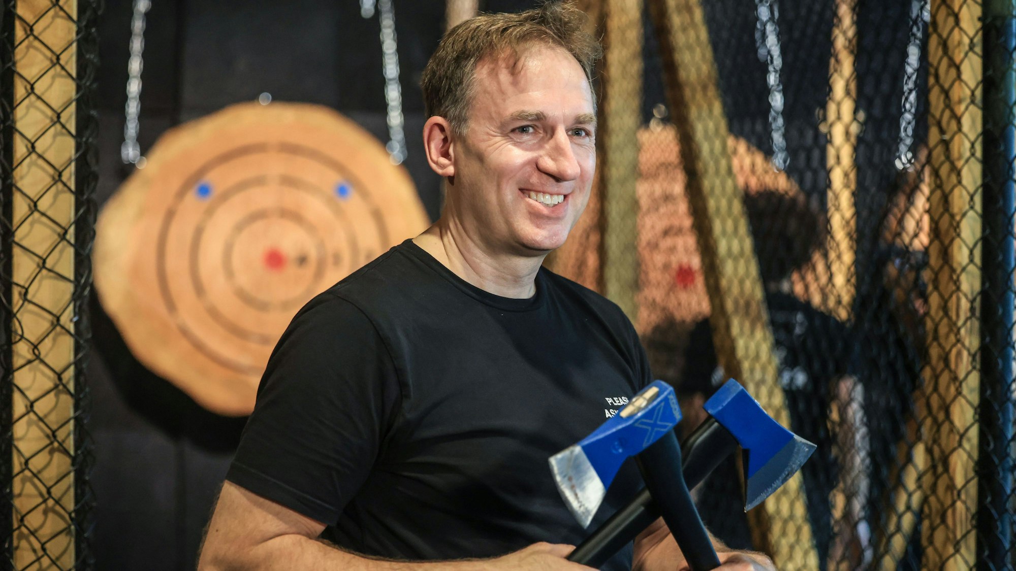 Deutschland-Geschäftsführer Martin Dencker demonstriert in der Kölner Filiale von „Wood-Cutter“ den richtigen Umgang mit den Sport-Äxten in der neuen Bar im Steigenberger-Hotel.