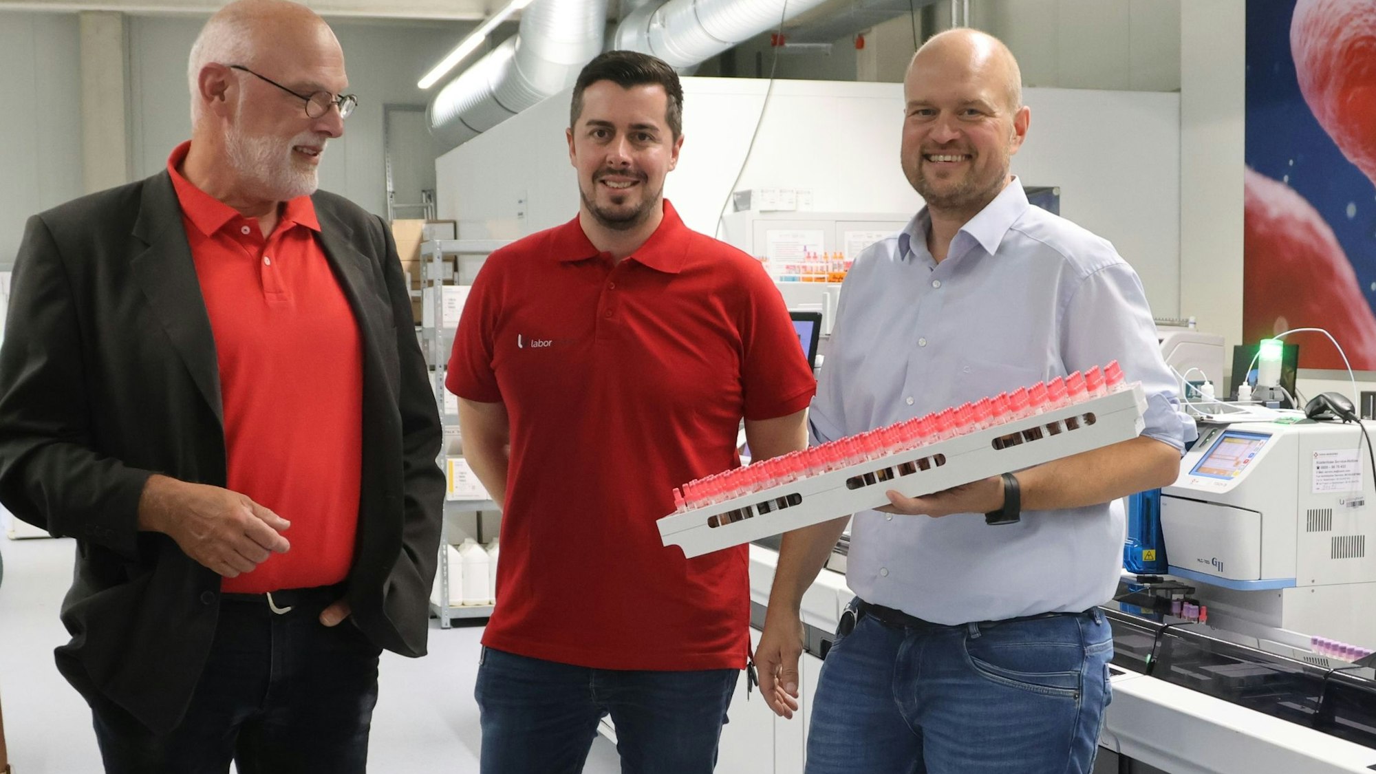 Benjamin Werner und Alexander Keil erläutern Gerald Zillig das Labor zur Blutuntersuchung.