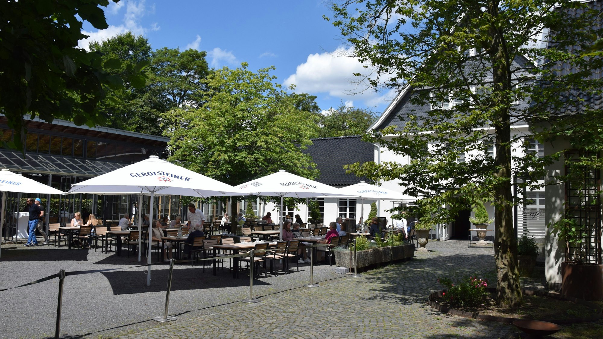 In einem Innenhof stehen Tische und Stühle.