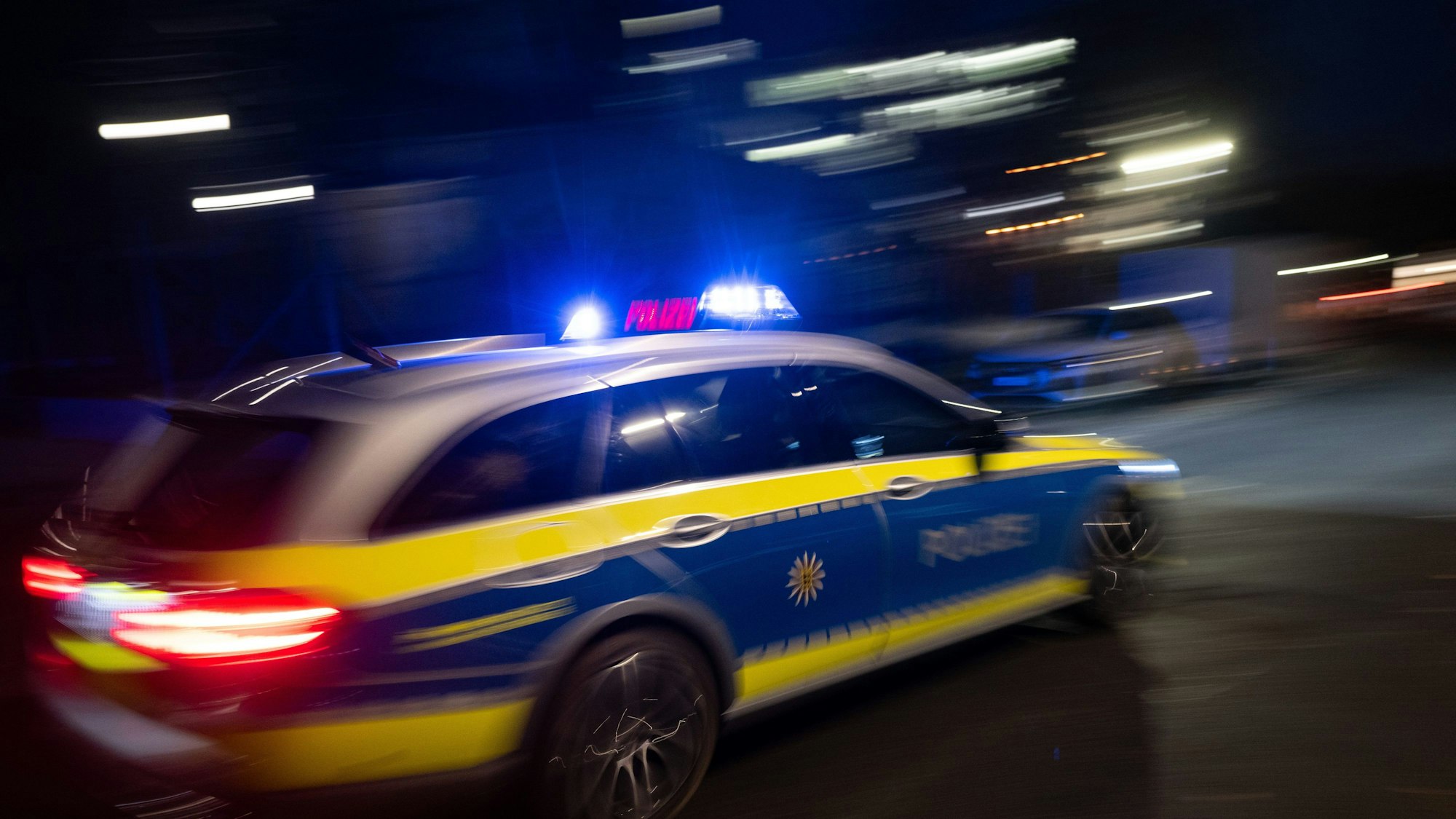 Das Bild zeigt einen Streifenwagen im Einsatz.