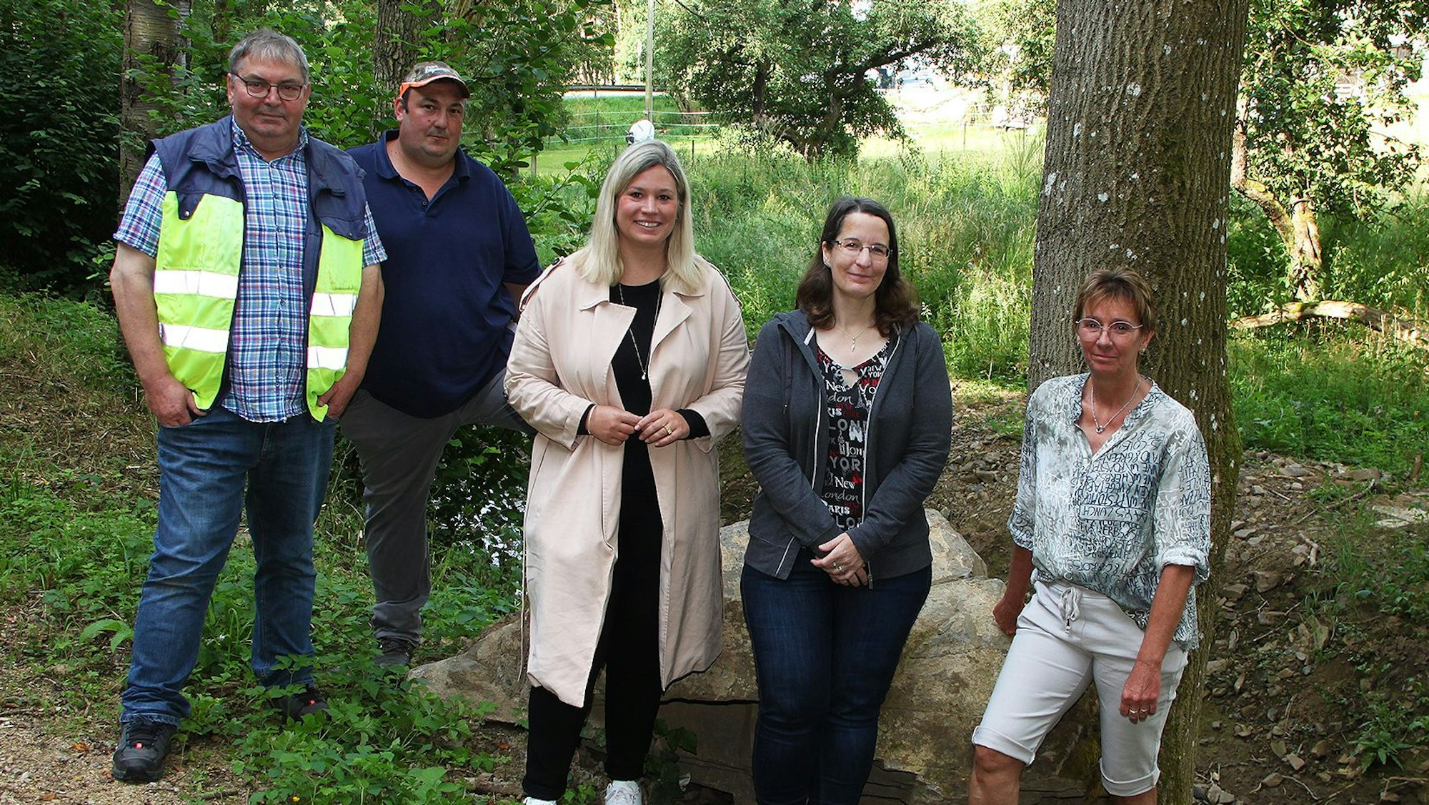 Blankenheims Bürgermeisterin Jennifer Meuren steht in der Mitte, rechts neben ihr sind zwei Frauen, links zwei Männer. Sie schauen sich die Maßnahmen zum Hochwasserschutz im Wald an.