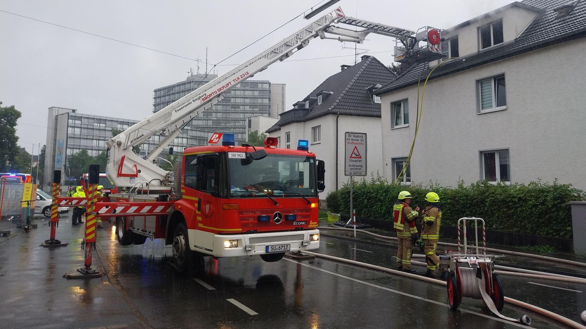 Eine Drehleiter der Feuerwehr steht auf der Straße.