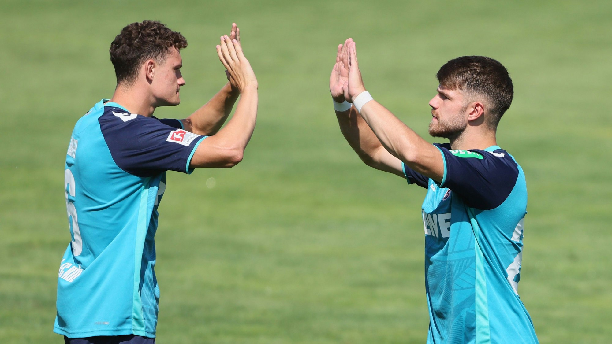 Mittelfeldspieler Eric Martel und Jan Thielmann vom 1. FC Köln klatschen sich nach einem Torerfolg im Testspiel in St. Veit an der Glan gegen Udinese Calcio ab.