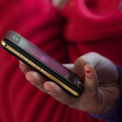 Ein Mädchen hält ein Handy in der Hand