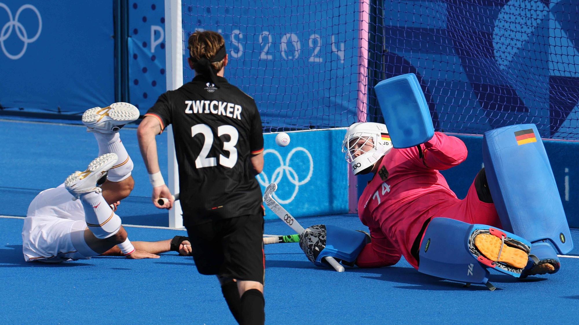 Germany's goalkeeper #74 Jean-Paul Danneberg saves a shot in the men's pool A field hockey match between Germany and Spain during the Paris 2024 Olympic Games at the Yves-du-Manoir Stadium in Colombes on July 28, 2024. (Photo by Ahmad GHARABLI / AFP)