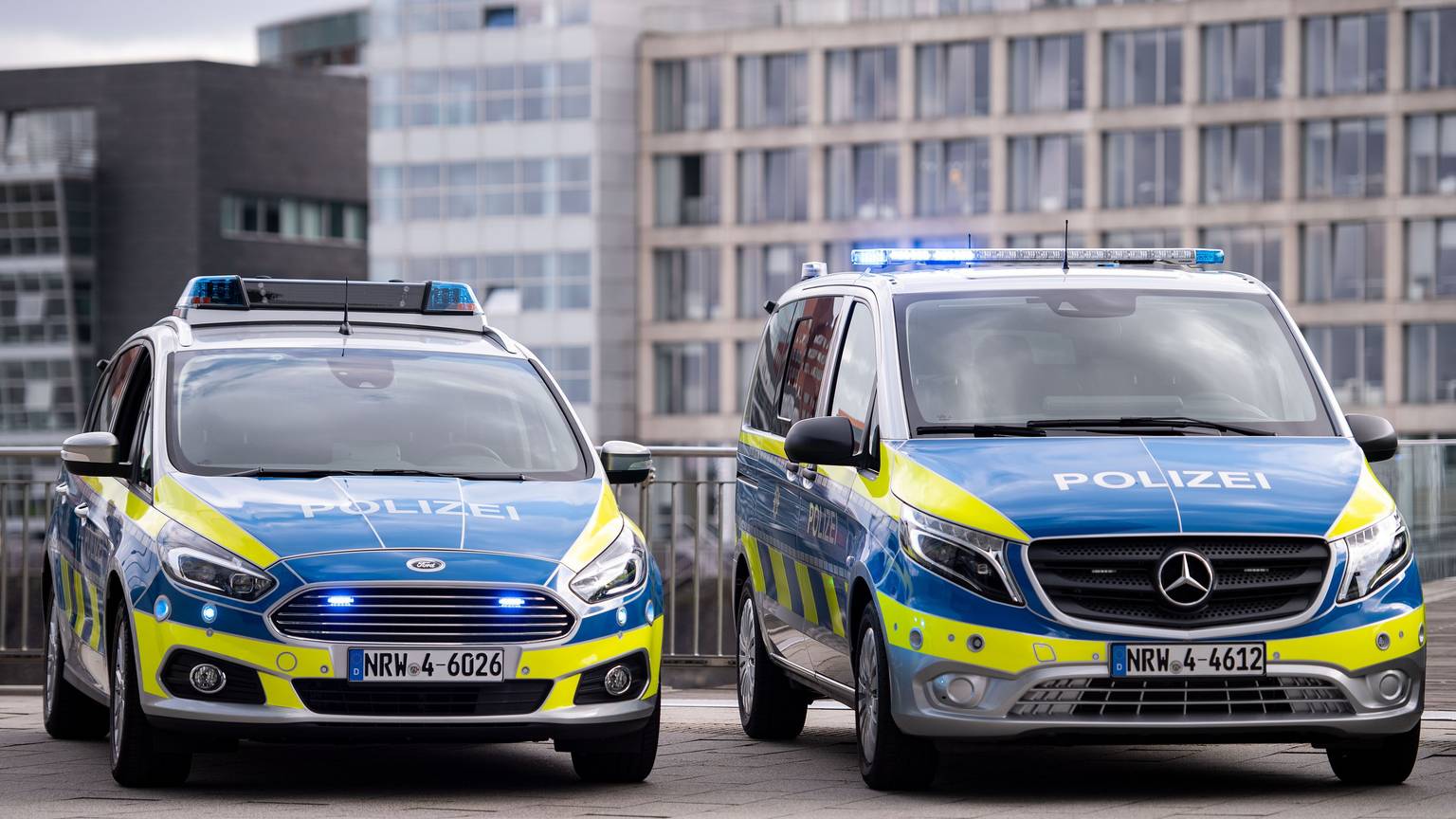 Neue Polizeiwagen vom Typ Mercedes Benz Vito (r) und Ford S-Max stehen im Düsseldorfer Medienhafen. (zu dpa: «NRW lässt 3000 ausgemusterte Polizeiautos versteigern») +++ dpa-Bildfunk +++