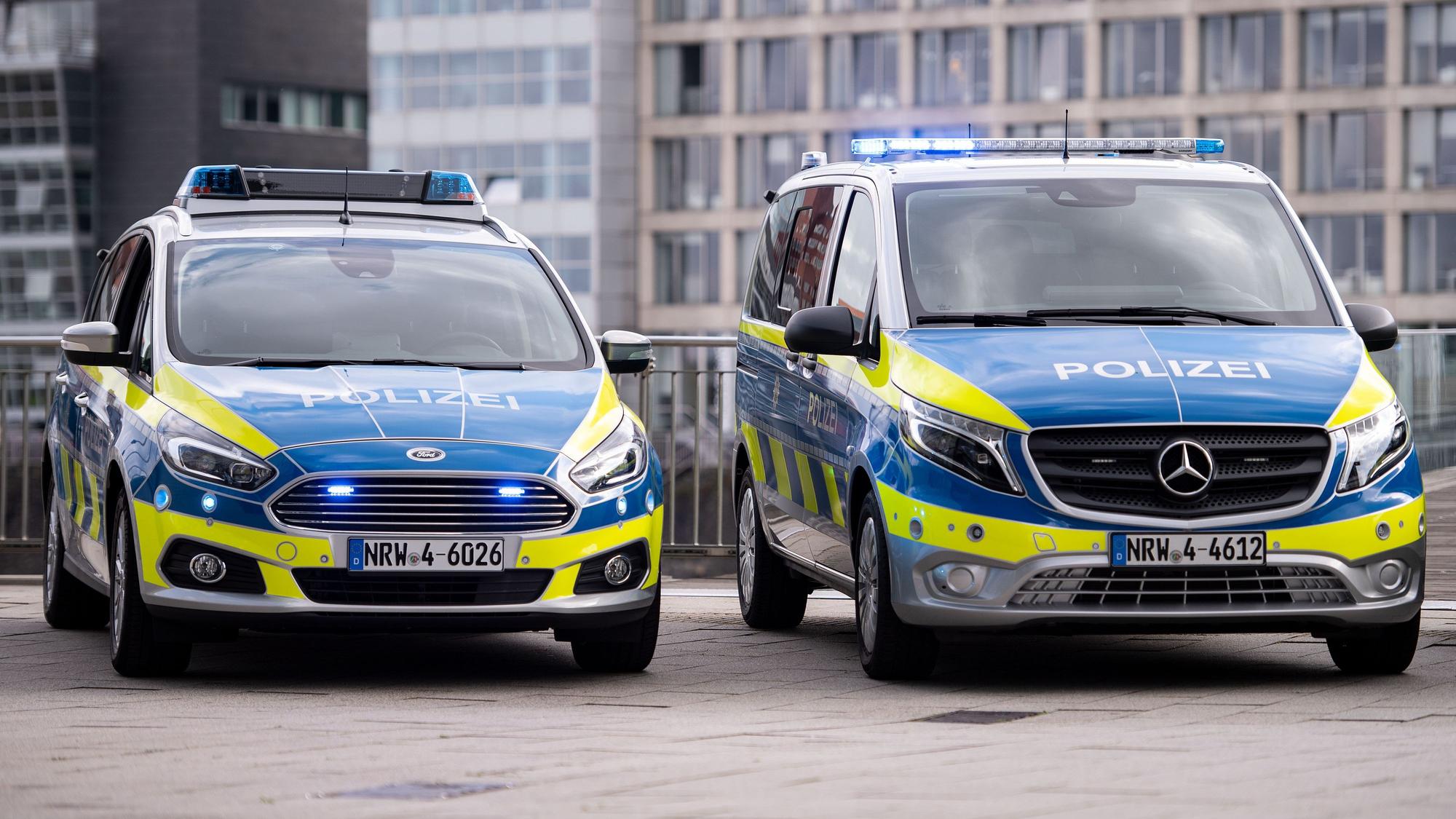 Neue Polizeiwagen vom Typ Mercedes Benz Vito (r) und Ford S-Max stehen im Düsseldorfer Medienhafen. (zu dpa: «NRW lässt 3000 ausgemusterte Polizeiautos versteigern») +++ dpa-Bildfunk +++