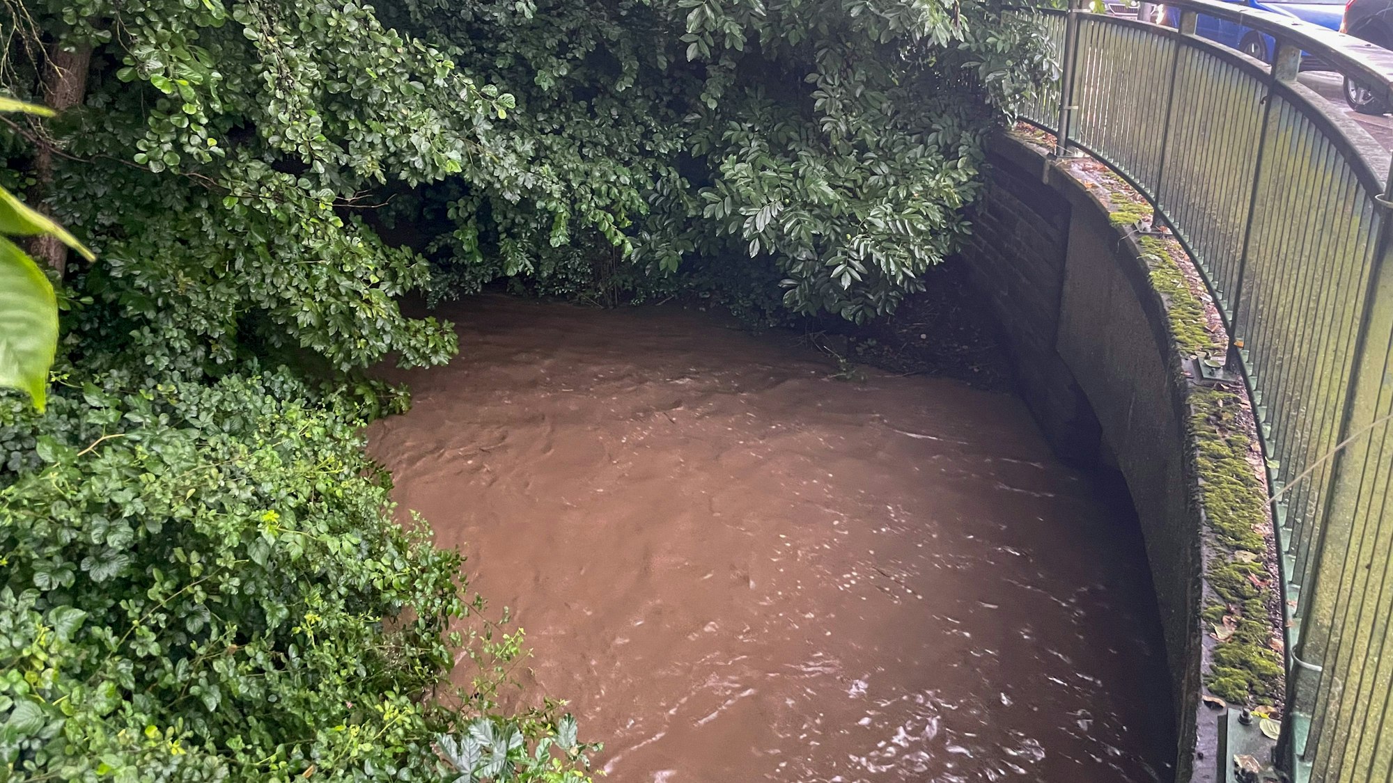 Das Wasser in einem Bach steht was zu einer Brücke.