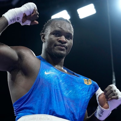 Germany's Nelvie Tiafack celebrates after defeating Italy's Diego Lenzi in their men's +92 kg quarterfinal boxing match at the 2024 Summer Olympics, Friday, Aug. 2, 2024, in Paris, France. (AP Photo/Ariana Cubillos)