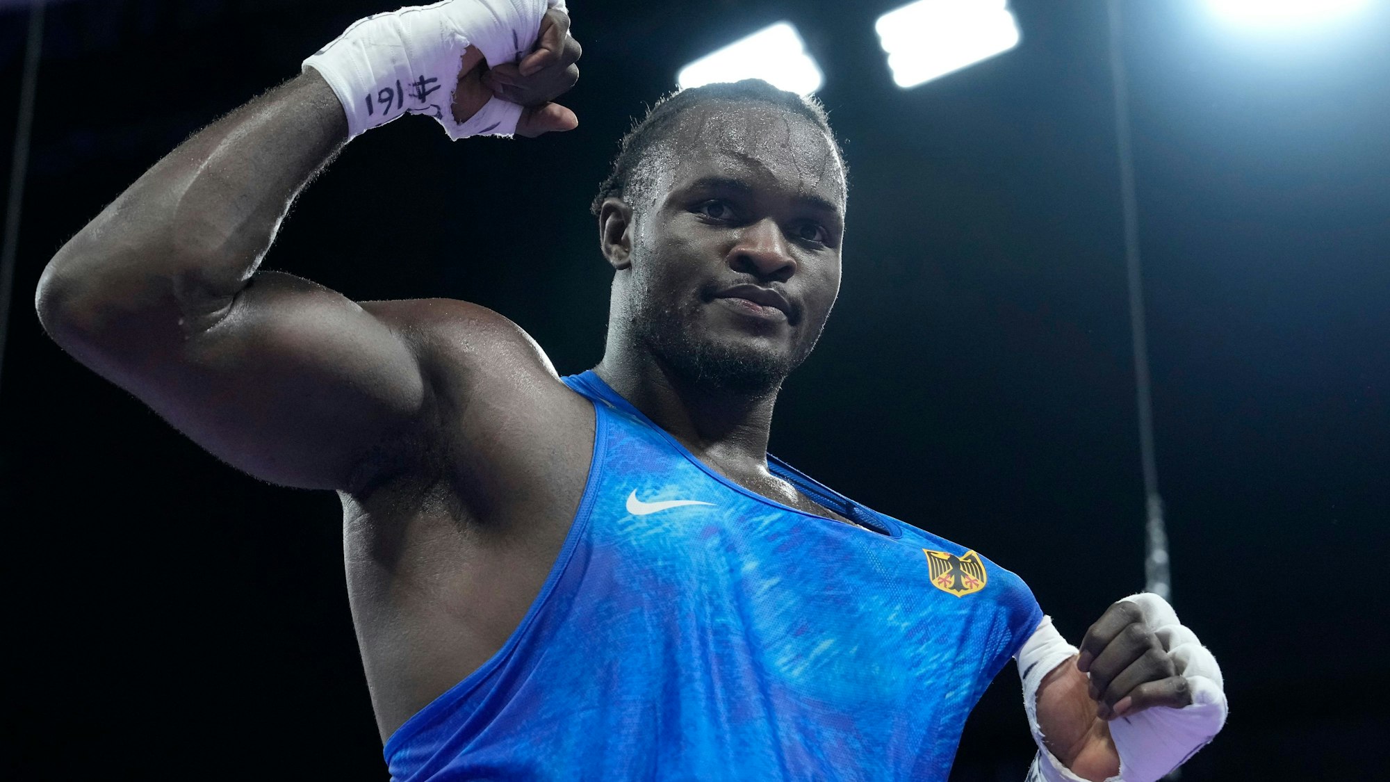 Germany's Nelvie Tiafack celebrates after defeating Italy's Diego Lenzi in their men's +92 kg quarterfinal boxing match at the 2024 Summer Olympics, Friday, Aug. 2, 2024, in Paris, France. (AP Photo/Ariana Cubillos)