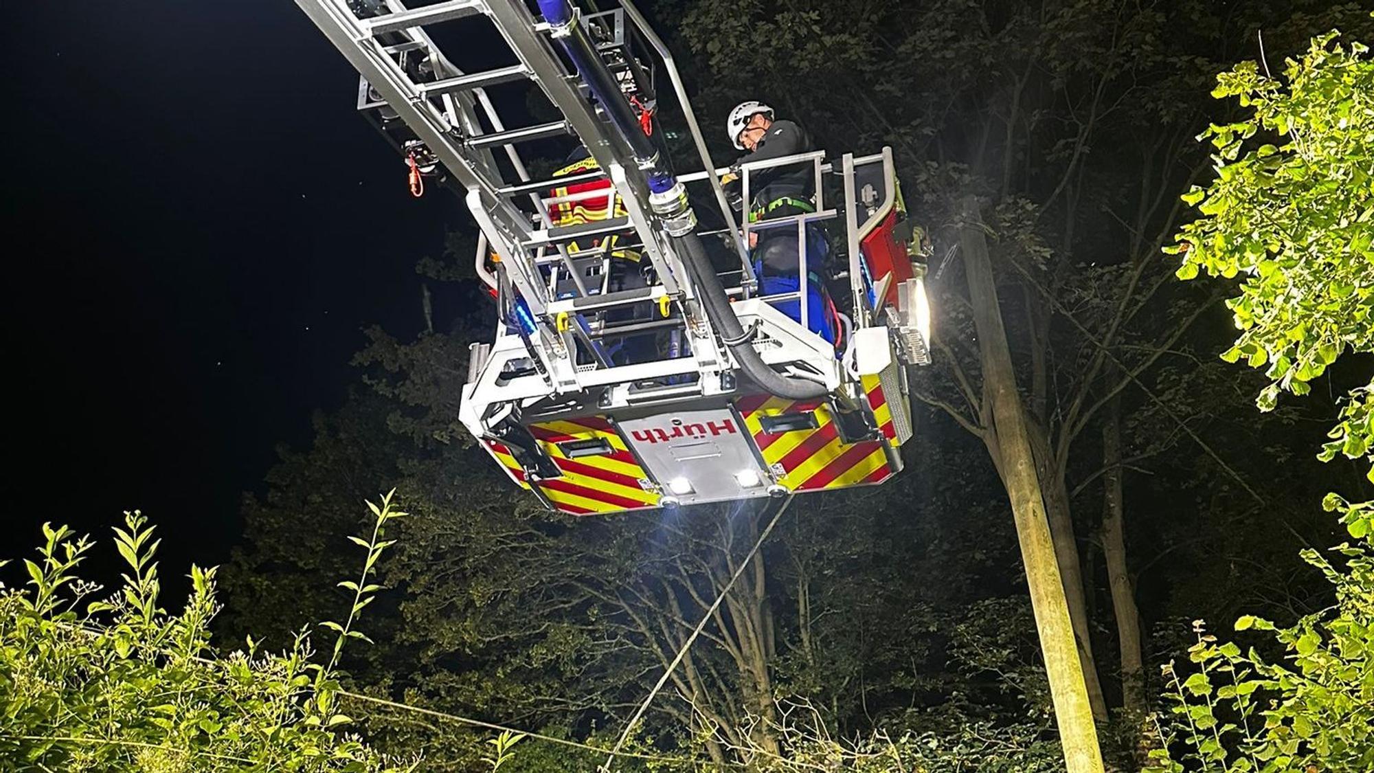 Ein Feuerwehrmann steht im Korb einer Drehleiter.